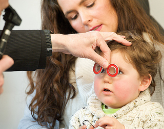 Child Eye Exam - AOP Image Library Child having eye examination with mother